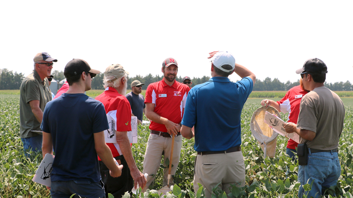 Back for its 27th year, Soybean Management Field Days combines time-tested agronomic insights with real-world results from the TAPS competition — helping growers turn innovation into action. In this photo, Nebraska Extension Entomologist Justin McMechan (center) shares pest management insights with producers during a 2024 Soybean Management Field Day stop. Nebraska Extension photo