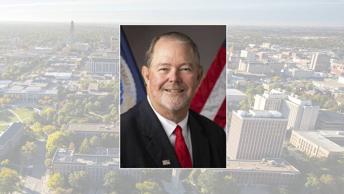 Color portrait of Scott Hutchins, chief scientist and undersecretary for research, education and economics with the U.S. Department of Agriculture, on a color campus background.
