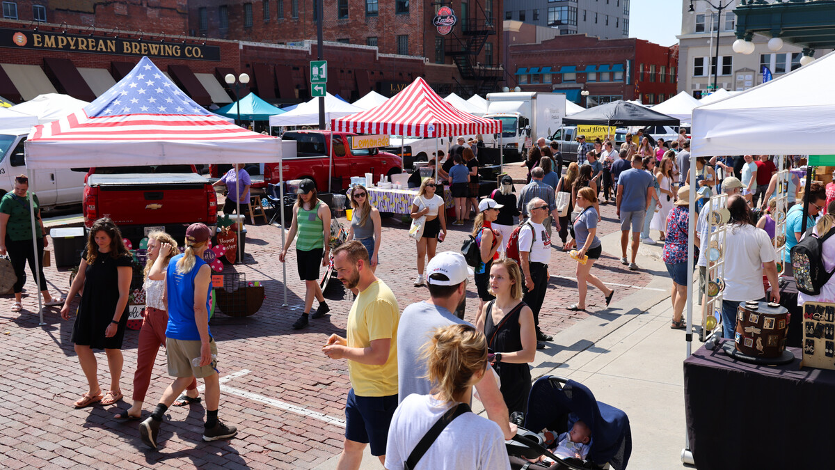 Marker goers walk the streets of the Saturday morning Haymarket Farmers Market in Lincoln