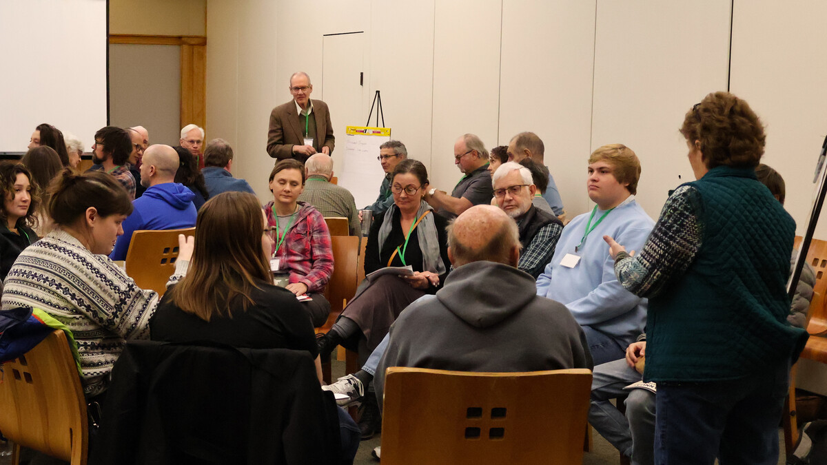 people gathered around a speaker