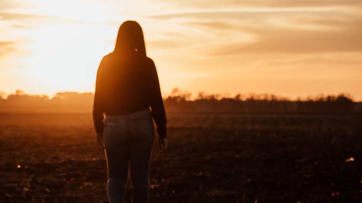 person walking in field 