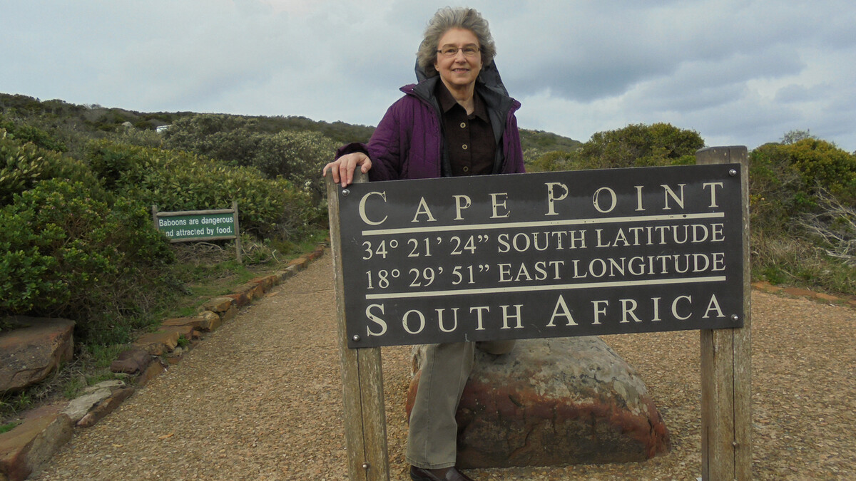 Nebraska's Sharon Hachtel stands by the Cape Point sign during a service trip to South Africa.