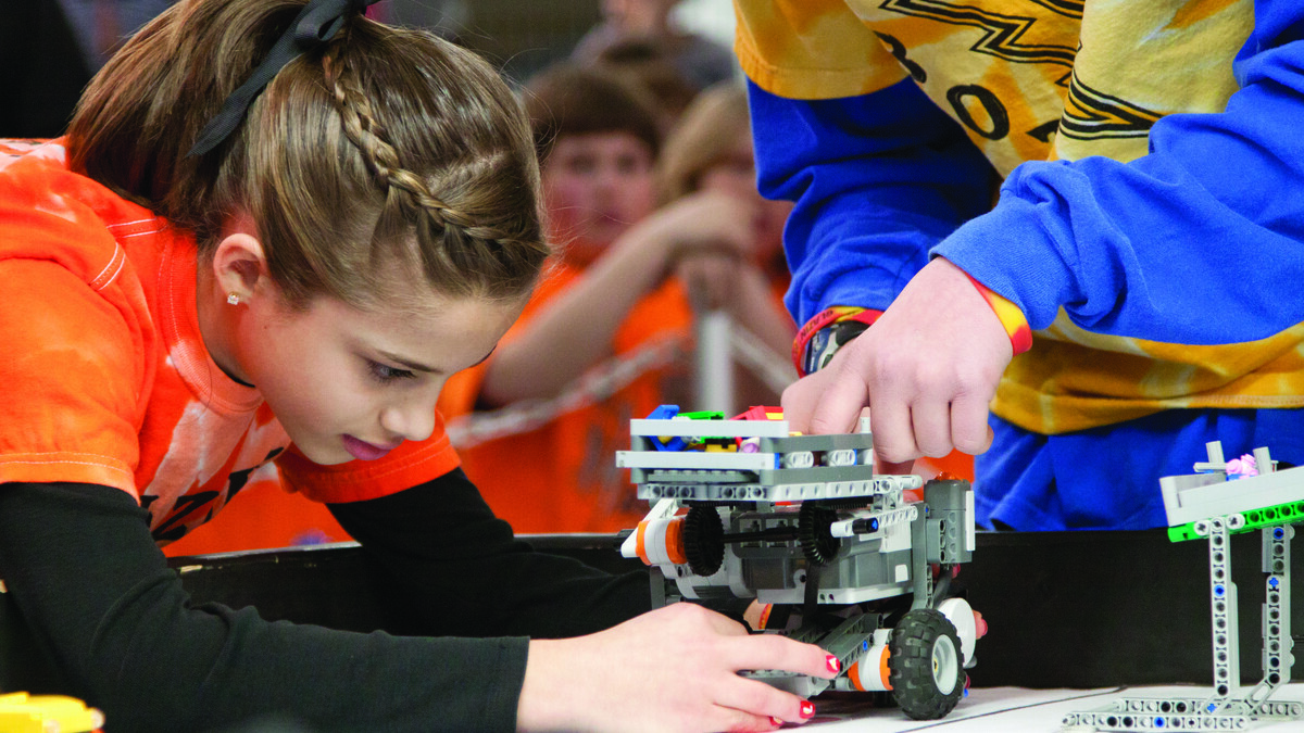 A student testing a wheeled robot. Links to larger image.