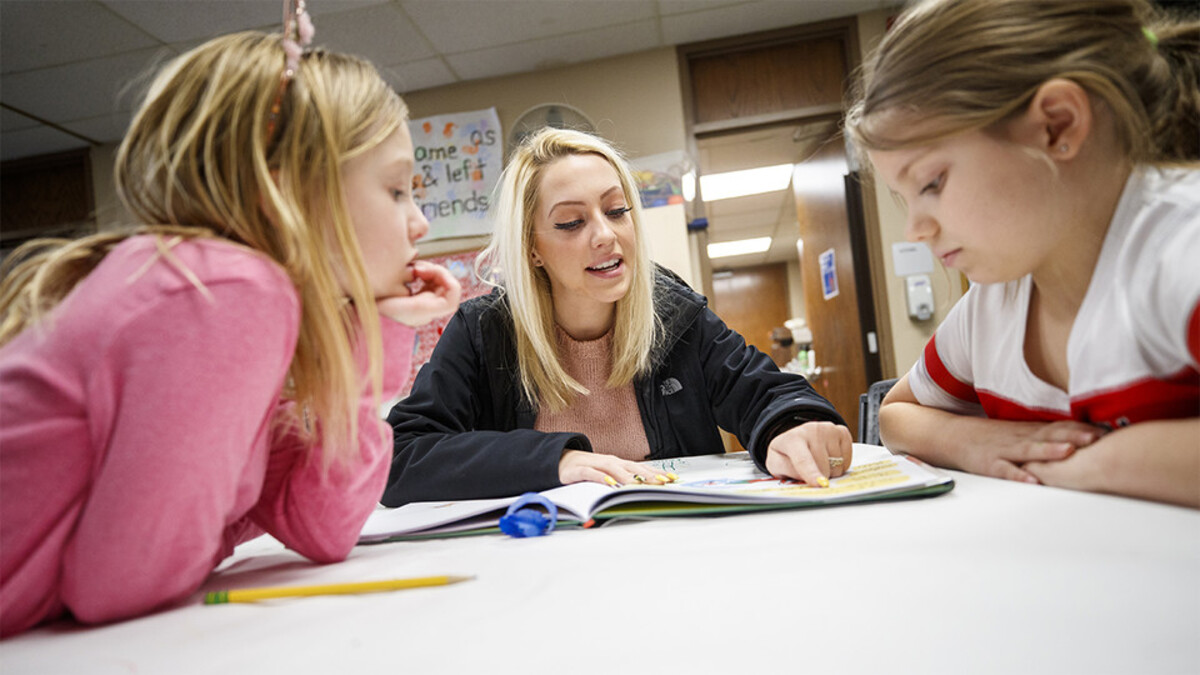 Jordyn Senstock reads to children at Lincoln's Northeast YMCA