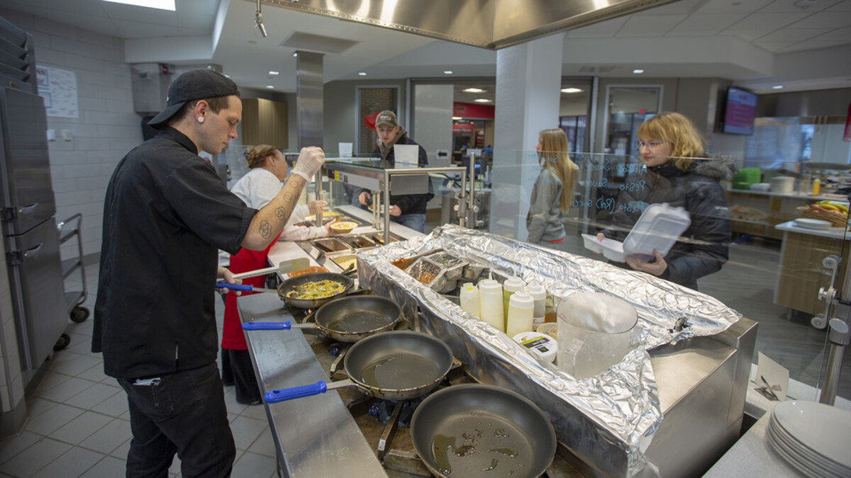 chef cooking in dining hall 