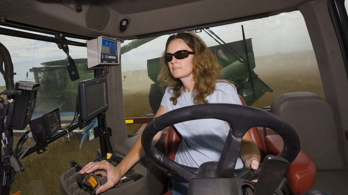 a woman driving a combine