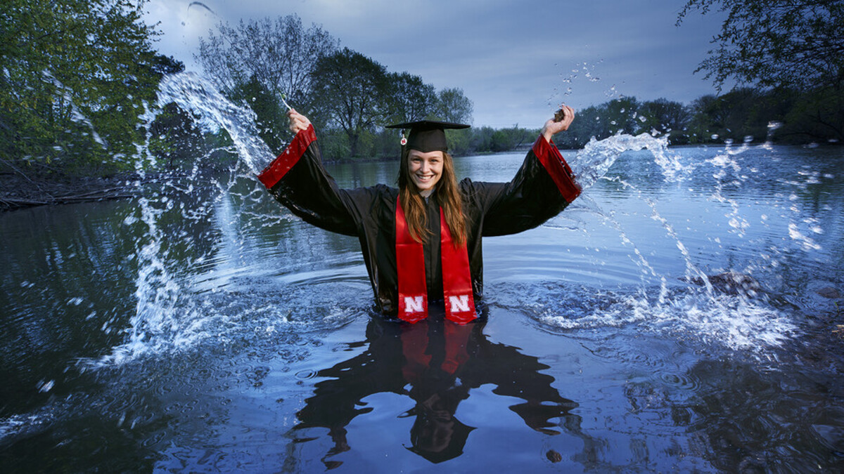 Vondracek in cap and gown in a lake
