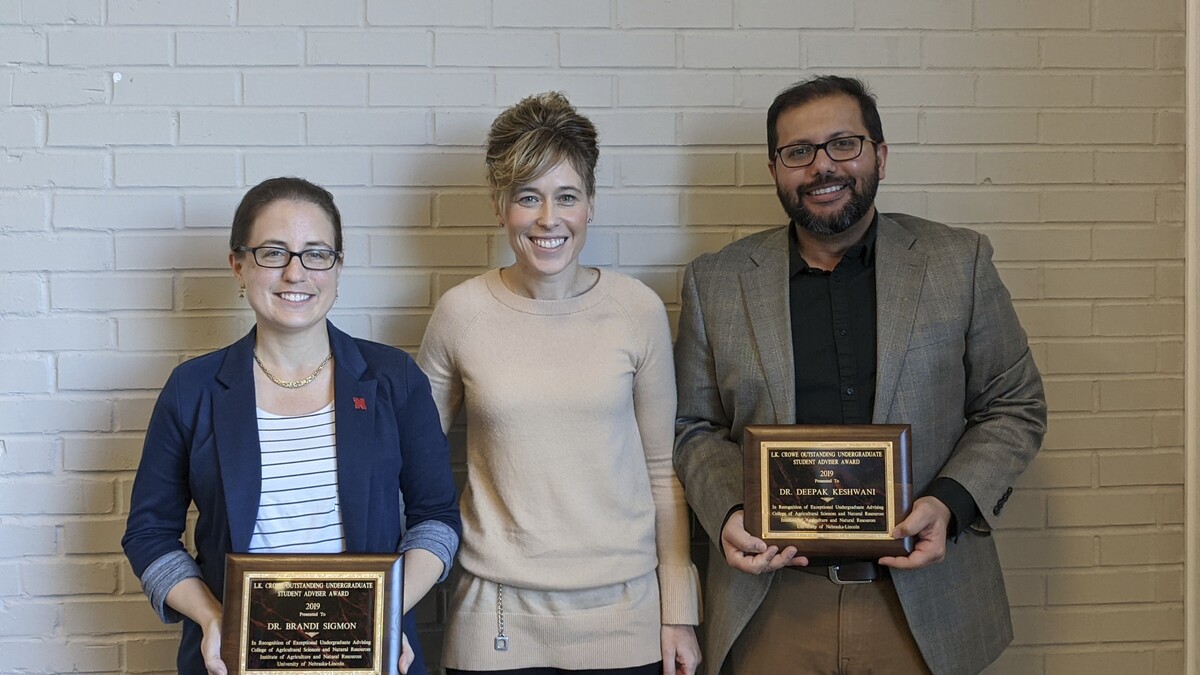 CASNR Dean Tiffany Heng-Moss (center) presents the Lawrence K. Crowe Outstanding Undergraduate Advising Award to Brandi Sigmon (left) and Deepak Keshwani (right).