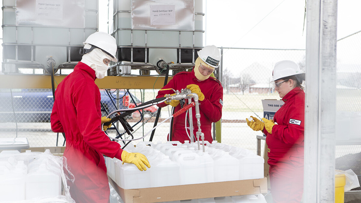 workers filling hand sanitizer bottles