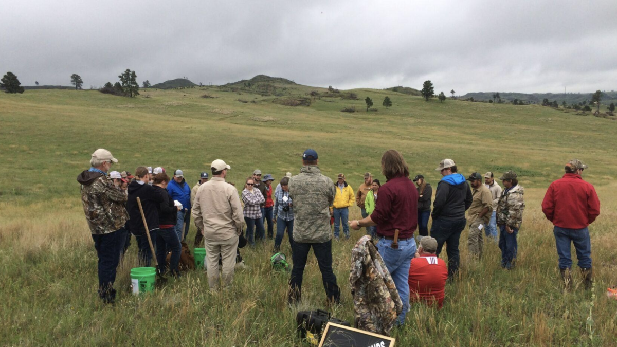 Short course program participants in a field 
