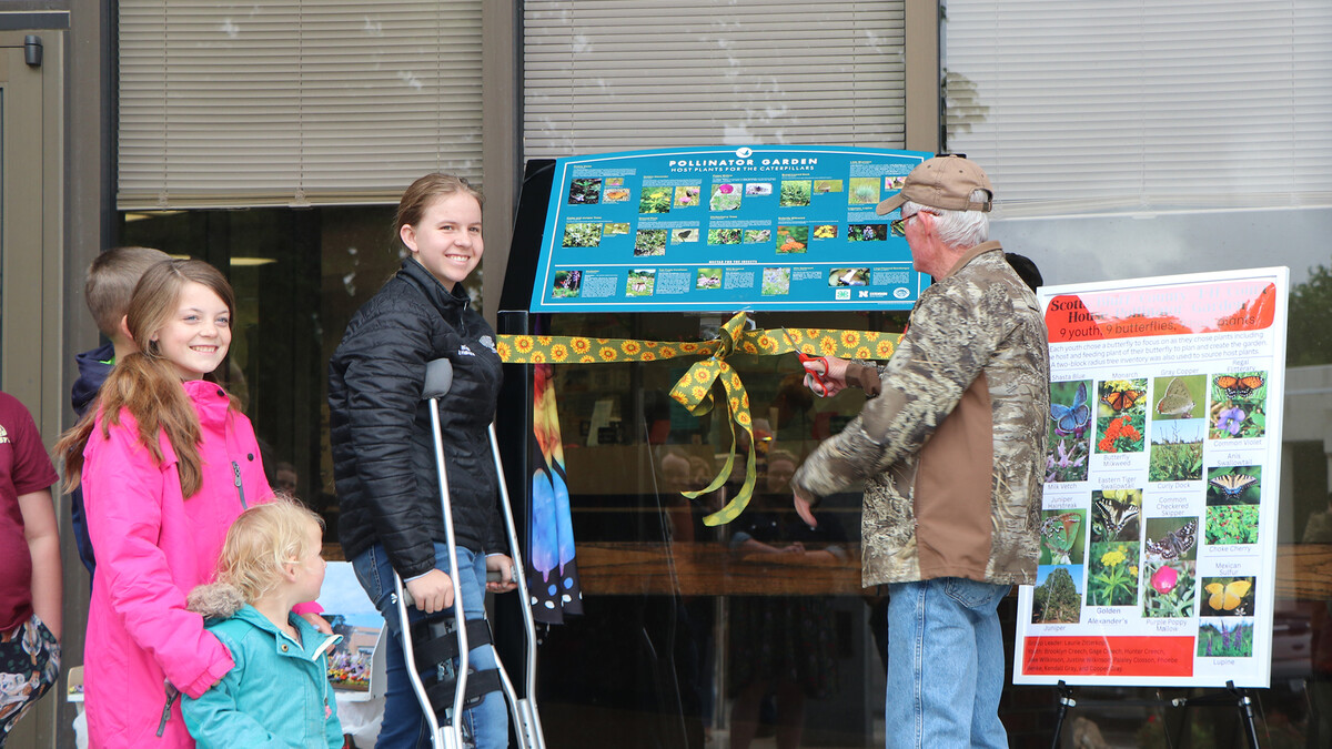 cutting ribbon in front of courthouse