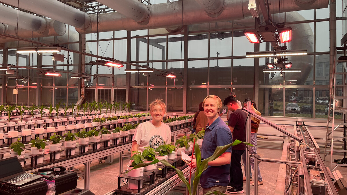 students in the east campus greenhouse