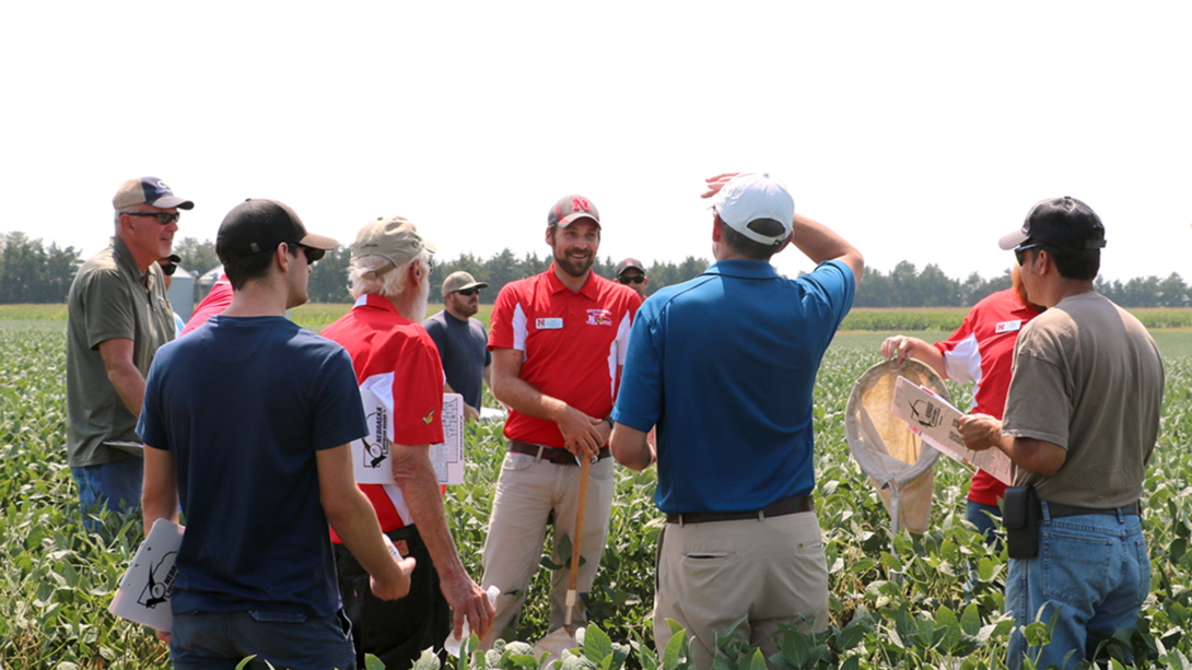Back for its 27th year, Soybean Management Field Days combines time-tested agronomic insights with real-world results from the TAPS competition — helping growers turn innovation into action. In this photo, Nebraska Extension Entomologist Justin McMechan (center) shares pest management insights with producers during a 2024 Soybean Management Field Day stop. Nebraska Extension photo