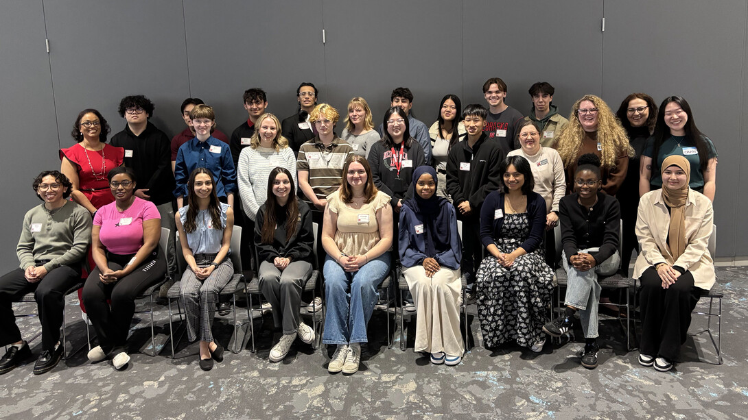 Twenty-seven men and women — all affiliated with the First Year Research Experience program at the University of Nebraska–Lincoln — pose for a group photo.