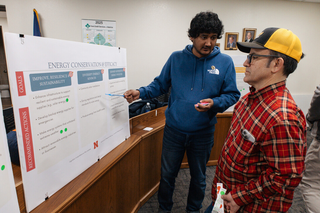 Pranjay Joshi, Master of Community and Regional Planning student, discusses energy conservation and efficacy goals with an Ogallala community member.