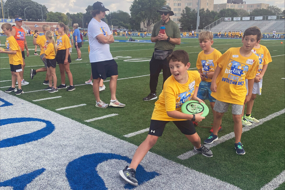 Elementary-aged children participate in various activities at a past Nebraska Kids Fitness and Nutrition Day. 