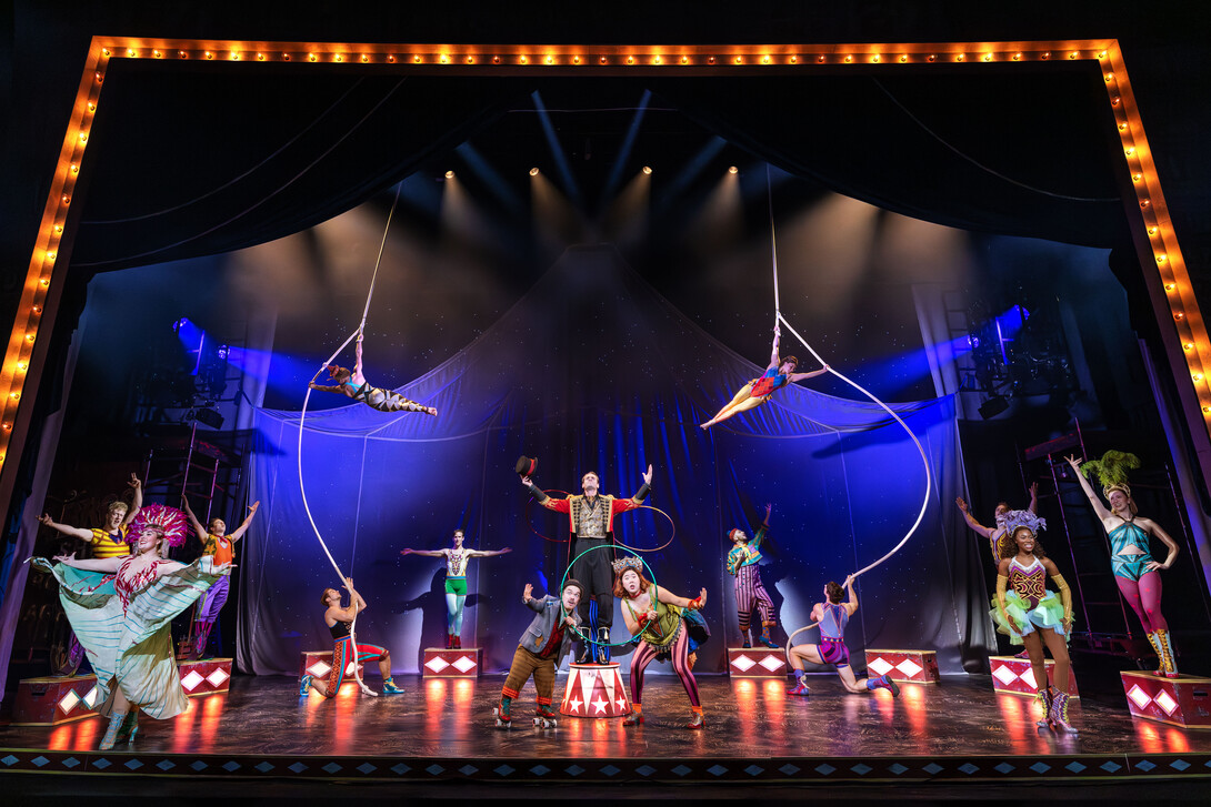 Acrobats and circus performers on a stage.