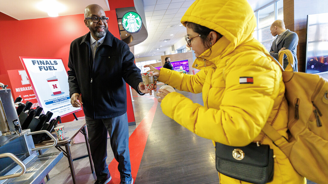 Chancellor Rodney D. Bennett serves coffee to students inside the Nebraska Union on Dec. 16. The coffee is available for free to students during finals week in the Nebraska Unions.
