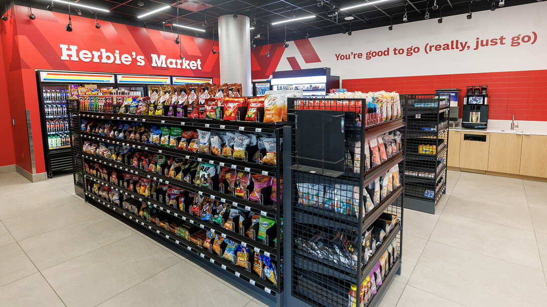 Wide view of the new Herbie's Market in the Nebraska Union, showing the shelves and coolers in the space.