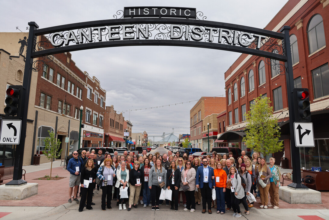 Participants at the 2025 CEC Conference gather for a photo op in North Platte’s Canteen District on Day 1 of the conference.”