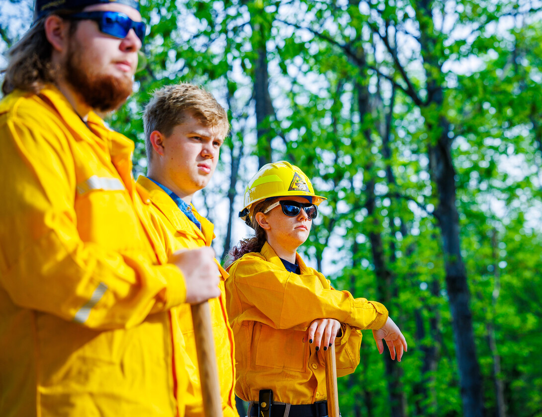 William Cunningham (center) listens as instructions are given during field training.