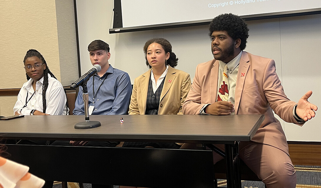 Marcus Cureton (right) answers a question about his research during a panel discussion.