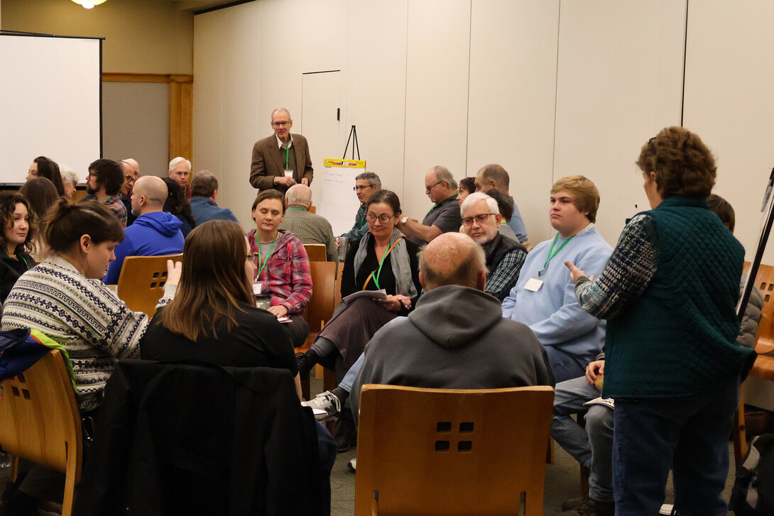 people gathered around a speaker