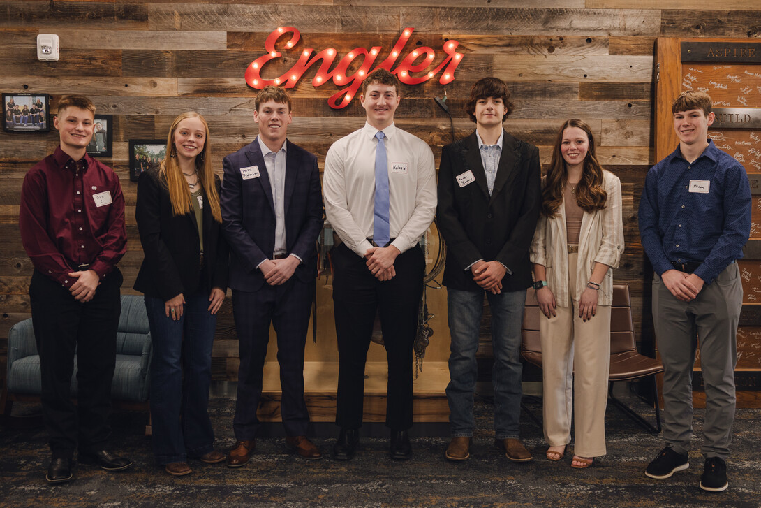 students standing in front of Engler sign 