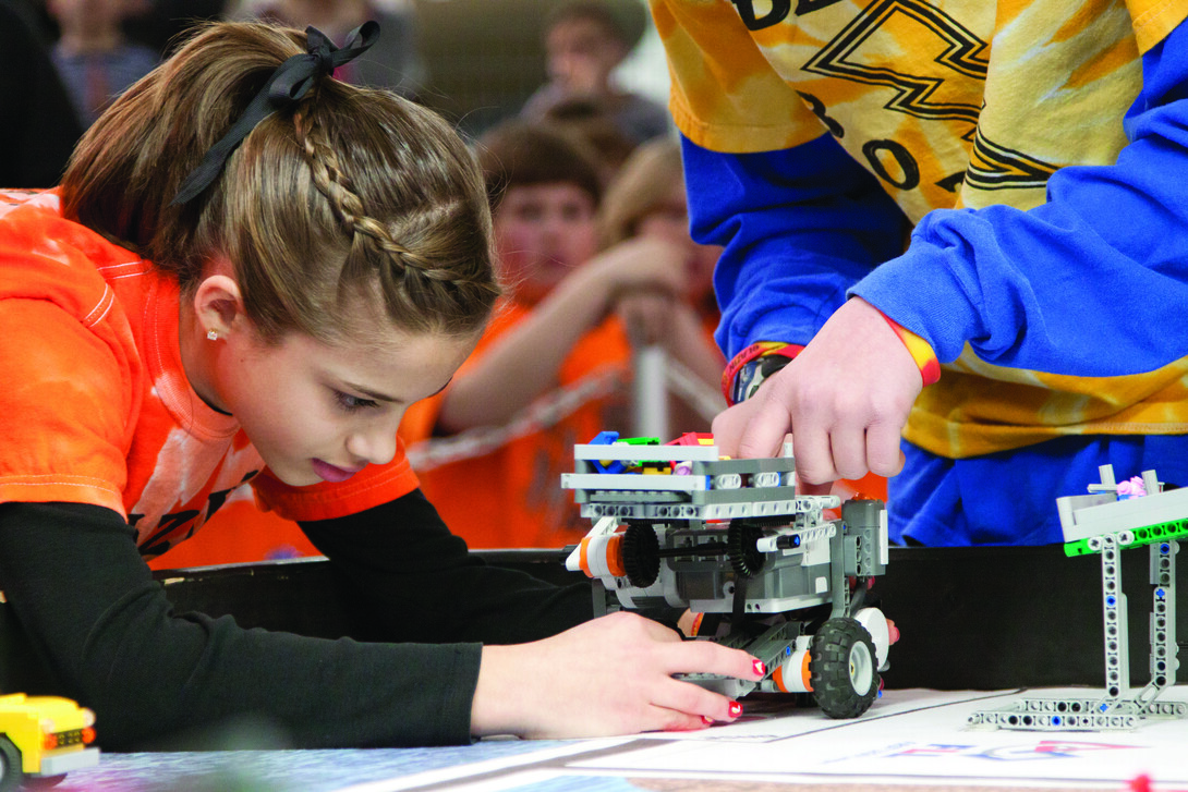 A student testing a wheeled robot. Links to larger image.