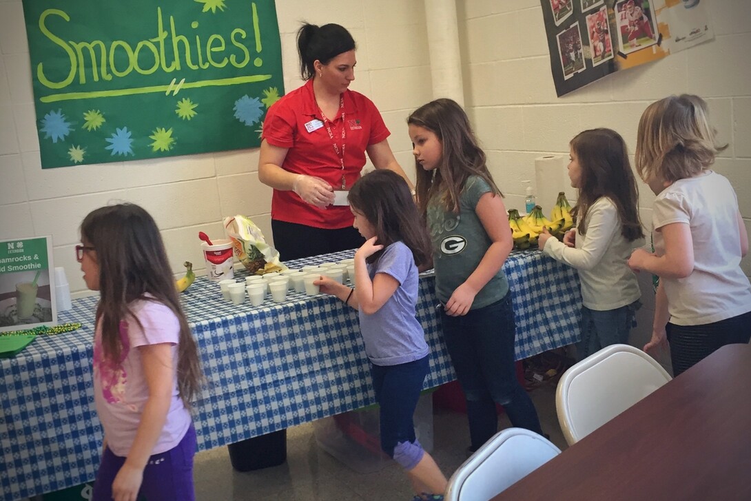 Nebraska Extension Educator Kayla Colgrove shares smoothie samples with Tri County Public Schools students during a recent farmers market held at the school.