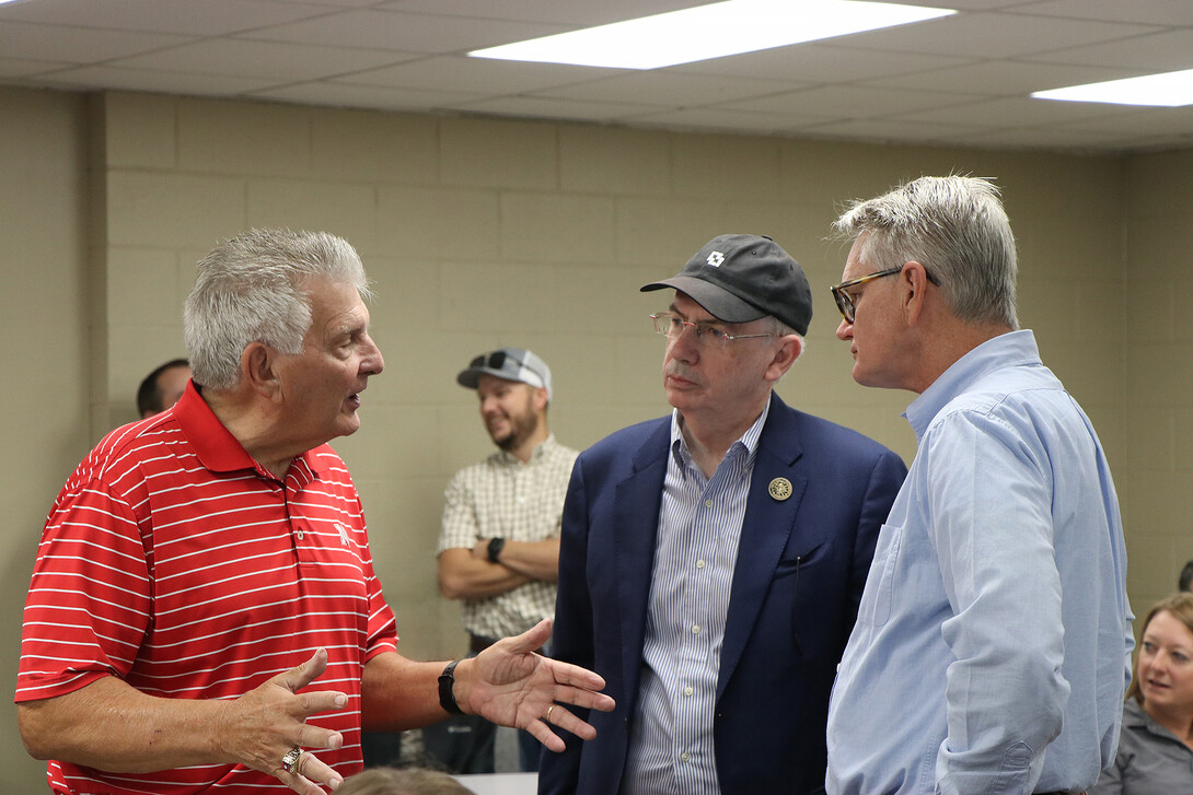 John Stinner, former Nebraska Senator, left, talks with UNL President Jeffery Gold and John Westra, 