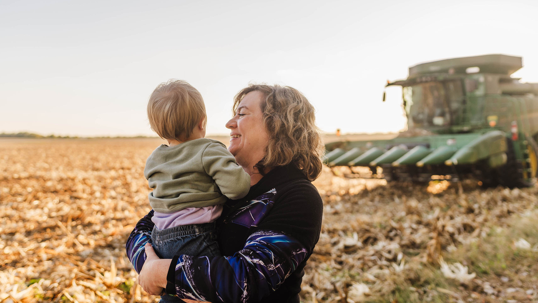 family in field with combine