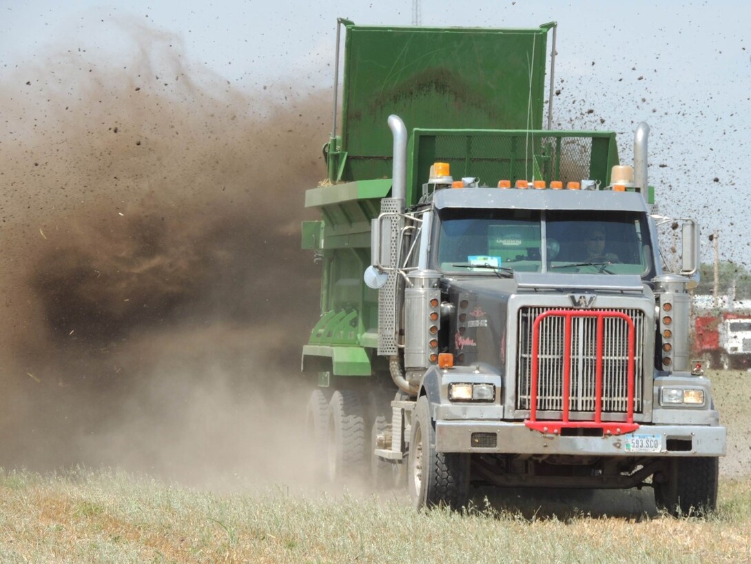 a truck spreading manure