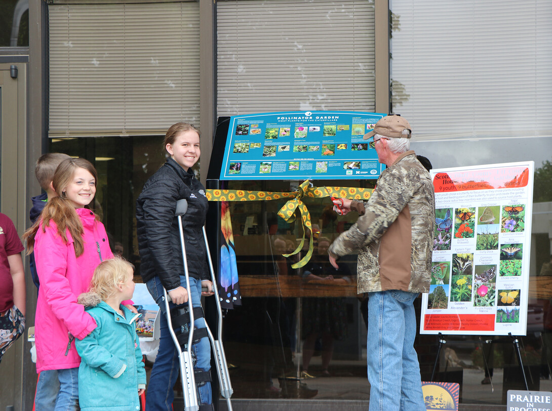 cutting ribbon in front of courthouse