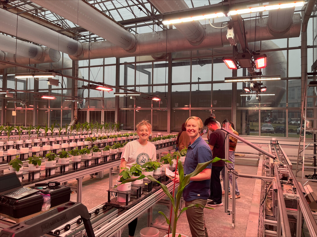 students in the east campus greenhouse