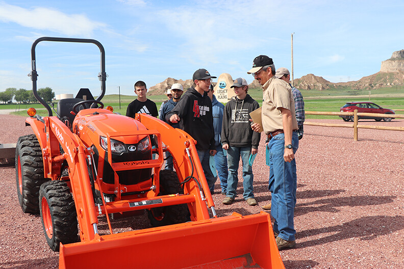 students with orange tractor