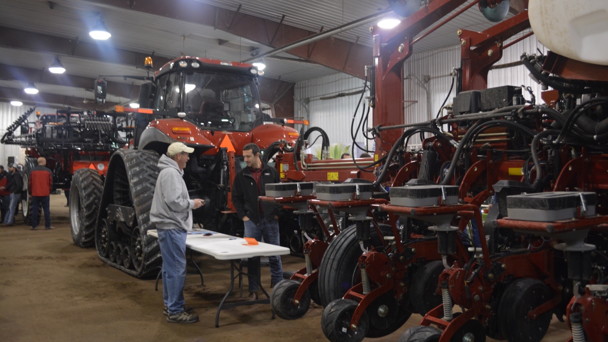 presenter showing tractors to participant at 2018 Soybean Day and Machinery Expo