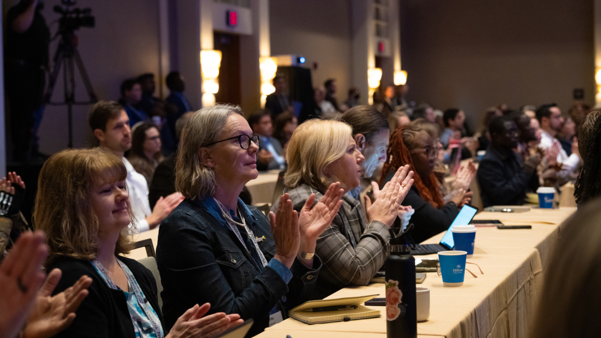 conferece attendees clapping