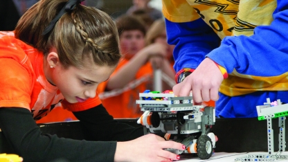 A student testing a wheeled robot. Links to larger image.