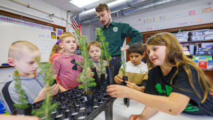 Jack Hilgert, Conservation Education Coordinator for the Nebraska Forest Service, answers second graders’ questions about their new blue spruce seedlings they will be growing in their Humboldt Table Rock Steinauer school classroom in Humboldt, Nebraska.