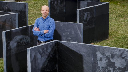 Daniel Ciobanu, professor of animal science, stands amid a maze-like sculpture.