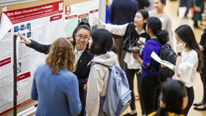 Students at a undergraduate research fair poster session